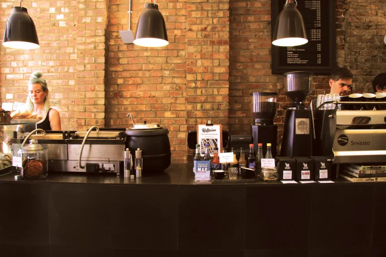 Coffee equipment beneath pendant lights at Kaffeine’s Great Titchfield Street counter