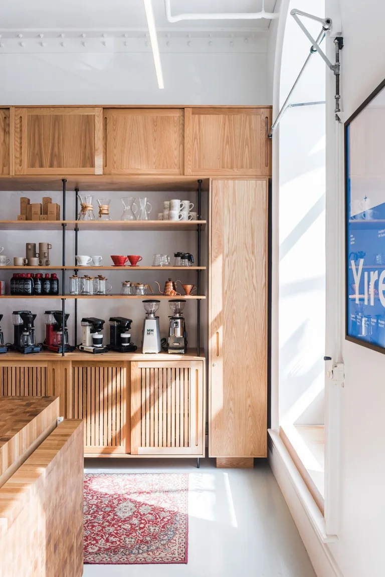 Wood-lined interior and retail shelves at Coffee Supreme’s Midland Park café