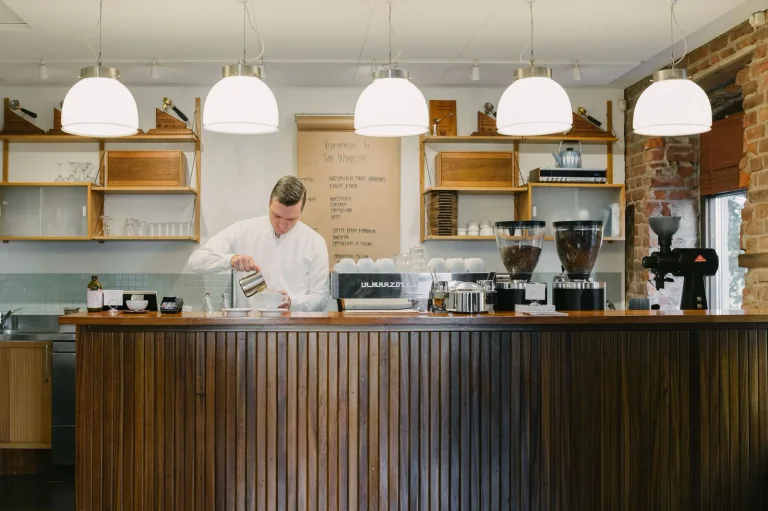 Barista and coffee equipment behind the counter at Tim Wendelboe’s Oslo espresso bar