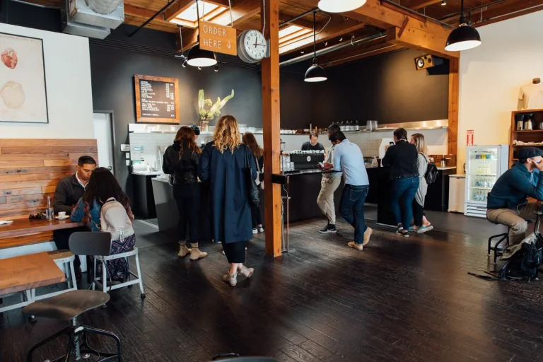 Customers and the wooden counter inside Heart Coffee on Burnside