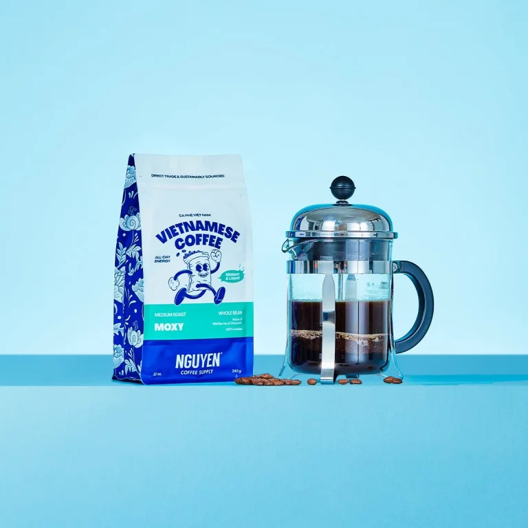 Arabica example: a 12 oz bag of Nguyen Moxy 100% Arabica whole-bean coffee beside a French press